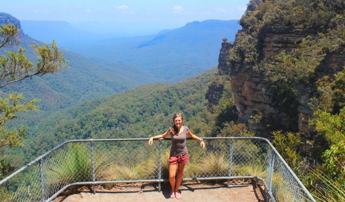 Female Lauren standing in front of lush Australian landscape