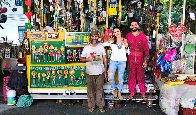 Celinne da Costa posing with some locals at their small souvenir stand