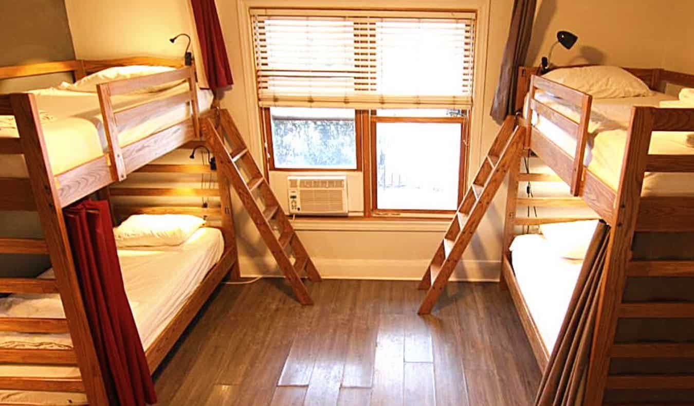 Dorm room with 2 wooden bunk beds at The Clarence Park in Toronto, Canada