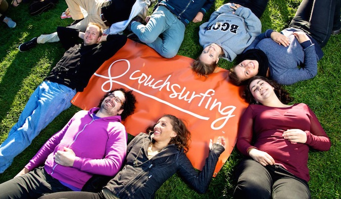 People in front of a Couchsurfing sign