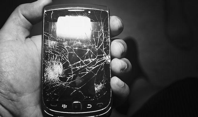 A black and white photo of a broke smartphone