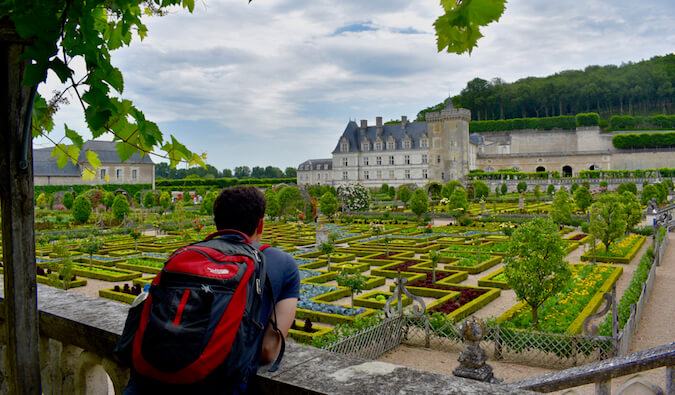 Nomadic Matt looking out at chateaux's in France