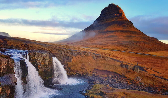 image of a waterfall in Iceland with a rock formation in the background