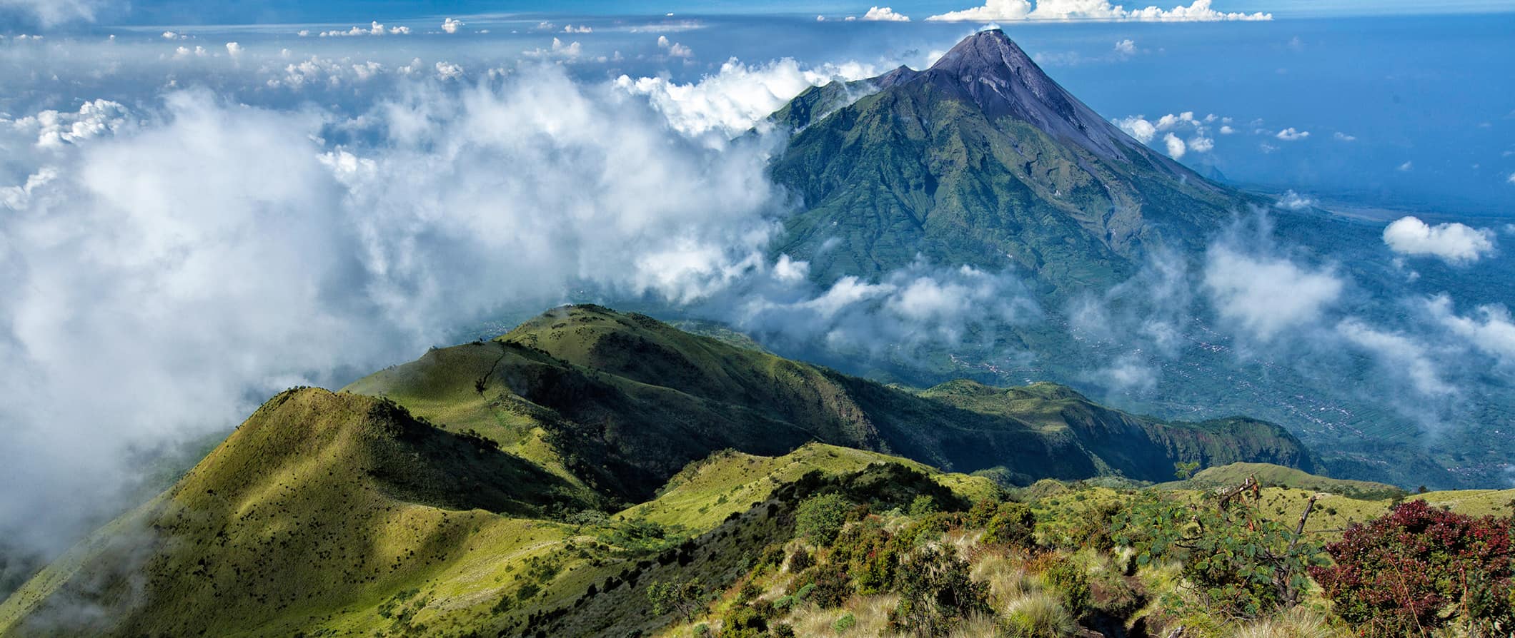 The verdant mountains and volcanoes in the lush landscapes of Indonesia