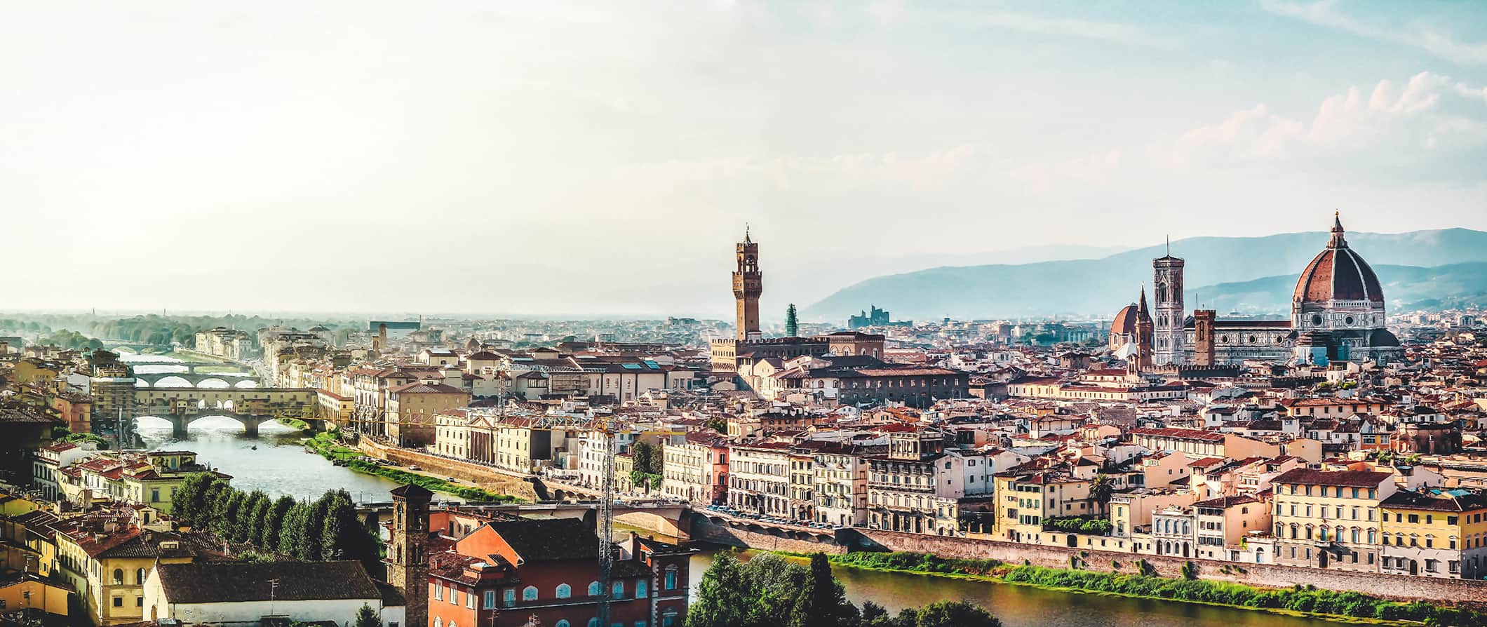 A beautiful view overlooking the city of Florence, Italy, with its stunning red roofs and mountains in the background