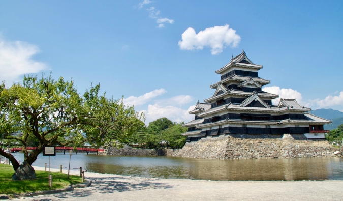 A large traditional castle in Japan on a sunny day