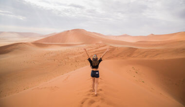 Kristin Addis walking on a sand dune