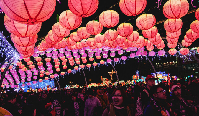 people celebrating under the pink and red lanterns at the lantern festival in Taiwan
