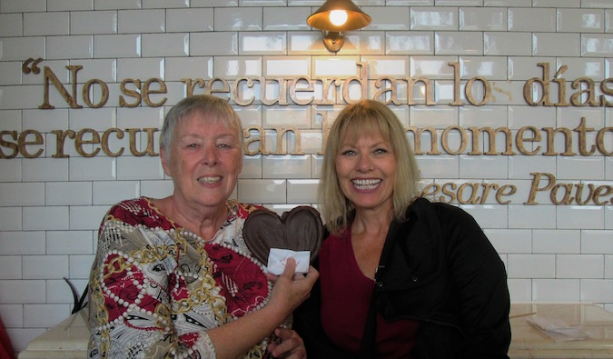 Two seniors travelers posing for a photo abroad in a restaurant