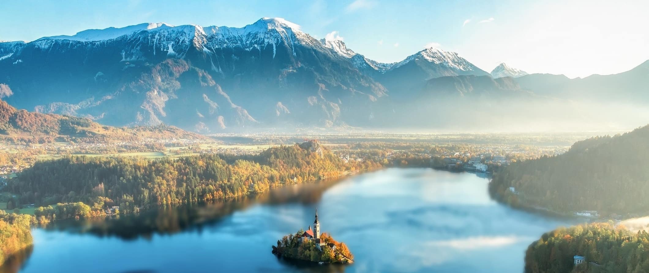 The mountains and lake surrounding the iconic and famous Bled Island in Slovenia