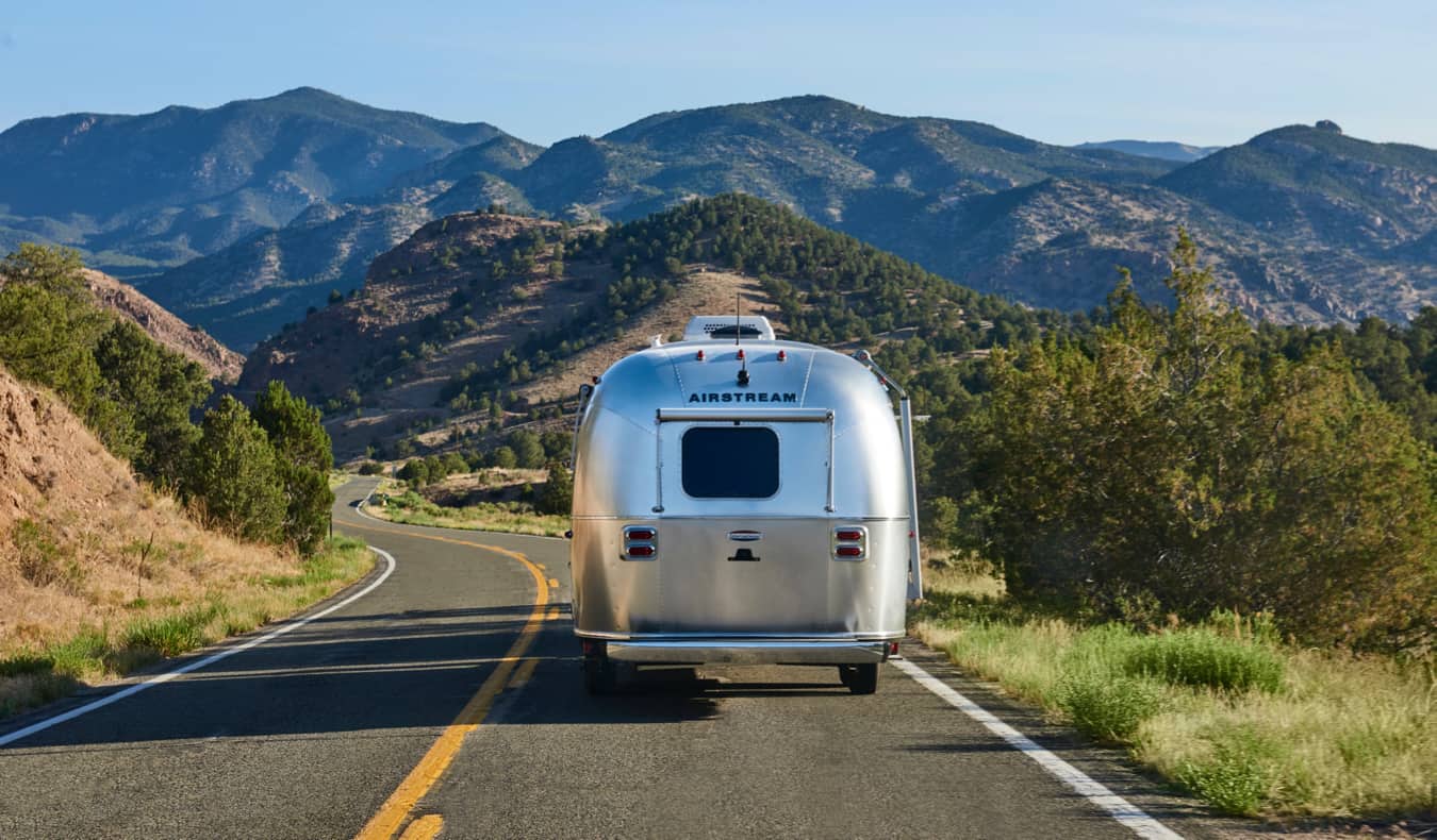 An old airstream RV cruising down the open road in the USA