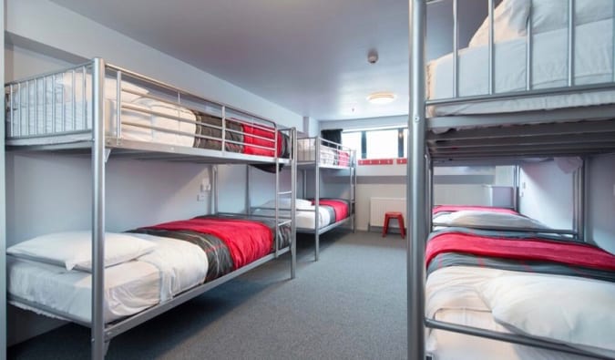 Dorm room with metal bunk beds at Urbanz hostel in New Zealand