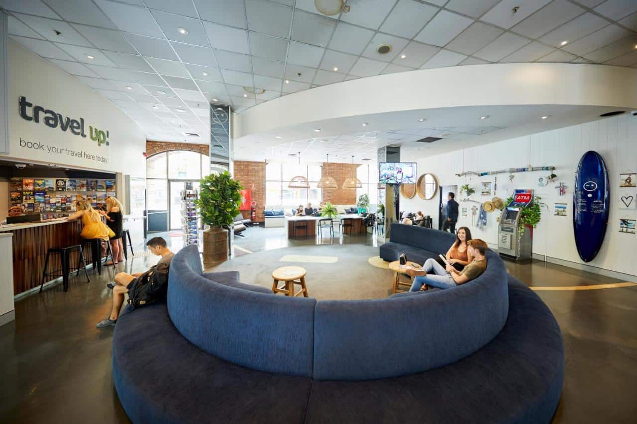 Lobby and common area with circular couch and front desk at Wake Up! in Sydney, Australia.