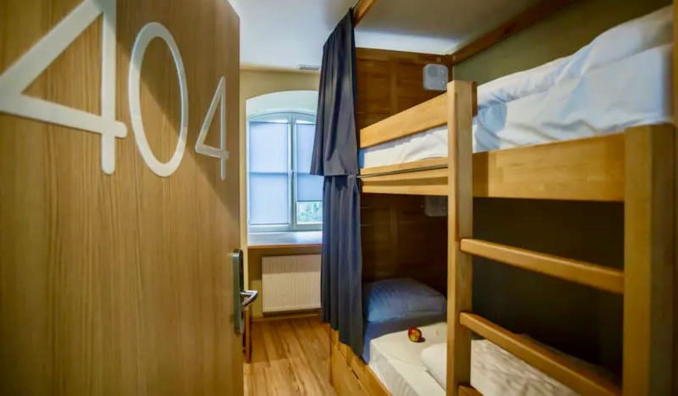 One of the cozy dorm rooms featuring bunk beds at Safestay hostel in Warsaw, Poland