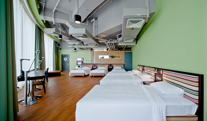 Large, spacious dorm room with double beds, twin beds, and a long desk at Y Loft, Hong Kong